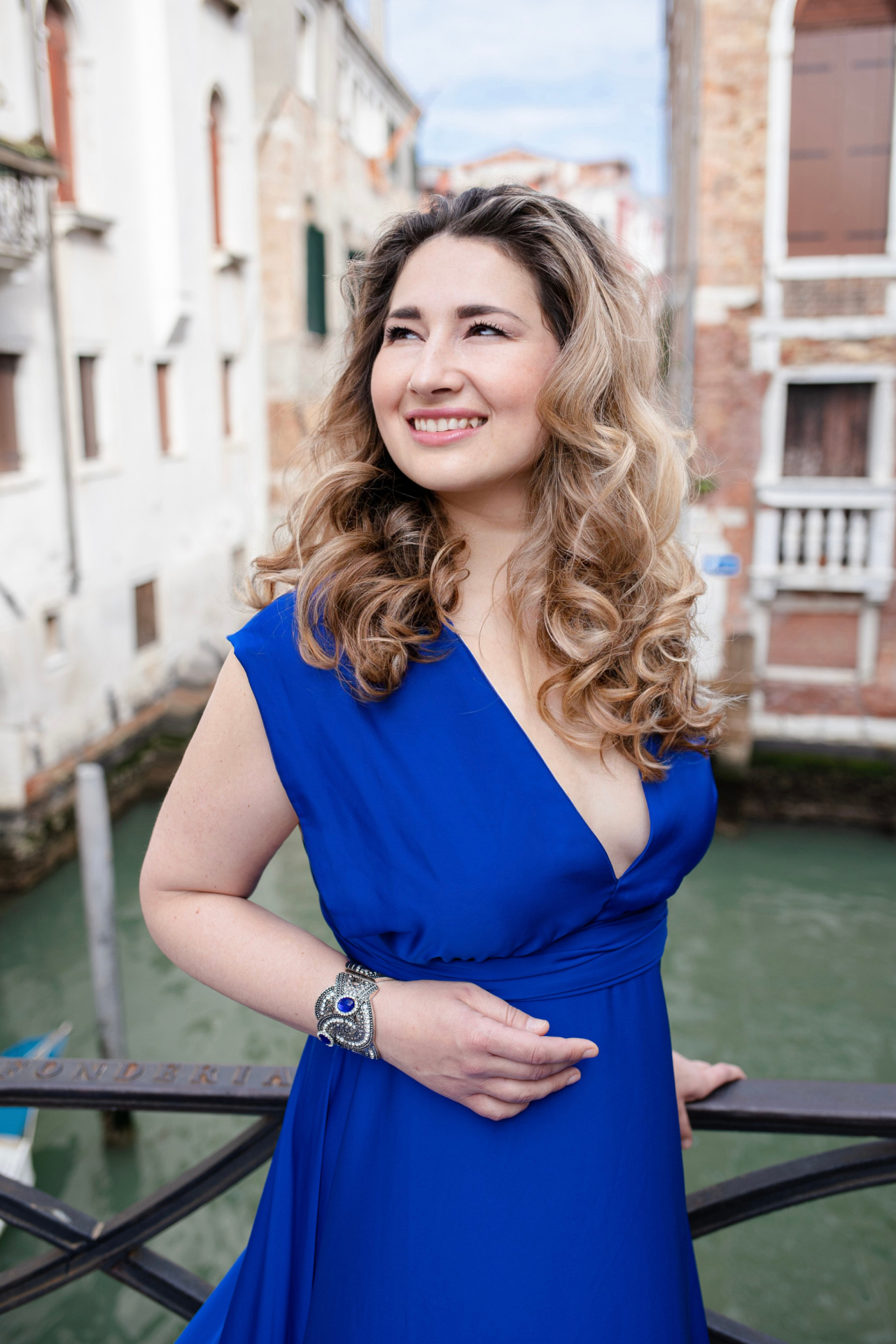 Anna Sanachina, soprano, on a Venetian bridge in a blue gown